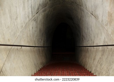 A Long Tunnel Down Into A Dark Dungeon.
