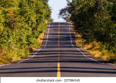 A Long Two Lane Rural Road Running Through A Colorful Vibrant Tr