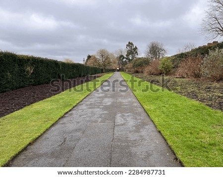 Long view down path along deep mixed borders at Belfast Botanics in February