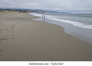 Long View Of Limantour Beach With Two Young Boys Running