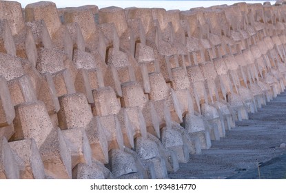 A Long Wall Of Neatly Stacked Tetrapods Used For Coastal Defence