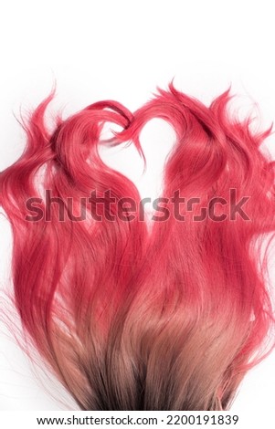 The long wavy hair texture, dyed ombre from natural dark to blond and to pink, formed a heart