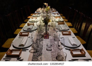 Long Wedding Banquet Table, White Tablecloth, Yellow Flowers And Ocher Chairs