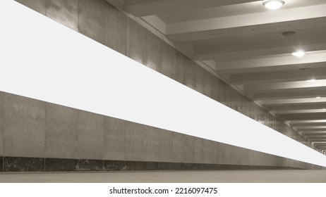 Long white commercial banner mounted on stone wall in underground passage side view - Shutterstock ID 2216097475