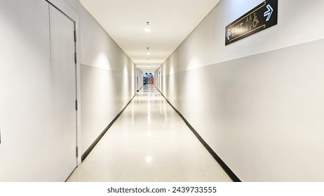 Long white corridor. Empty modern corridor. Long white corridor with Fire extinguisher. Empty modern bright corridor.