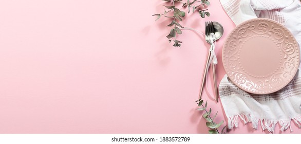 Long Wide Banner With Pink Empty Plate, White Napkin, Cutlery Set With Bow And Decorative Eucalyptus Twigs On Pink Pastel Background. Festive Table Setting For Valentine’s Day Or Easter Concept.