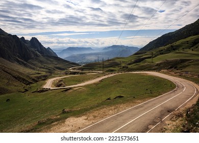 A Long Winding Mountain Road, Against The Backdrop Of High Relief, Sharp Mountains. Mountain Serpentine.