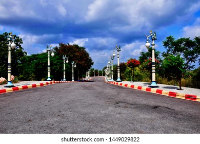 A Long Winding Road Looks Inviting For A Long Drive With Elegant Streetlights