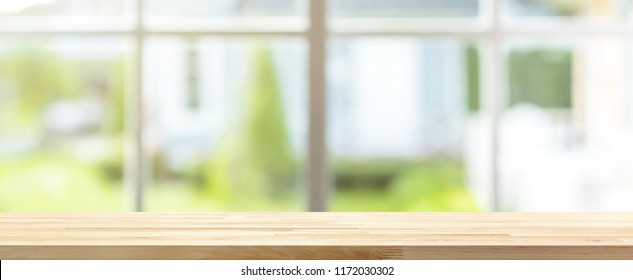 Long Wood Table Top With Blur Banner Background Of Green Garden Outside The Window, For Montage Or Display Your Products