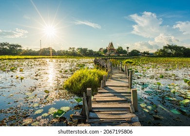 Long wooden bridge across the lake on sunset background at Kae Dam District, Maha Sarakham Province, Thailand
