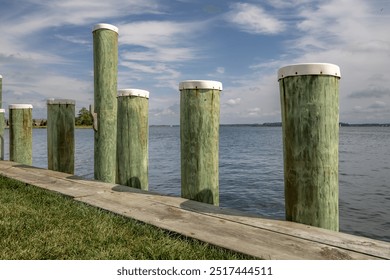 Long wooden dock, pier, with a cloudy sky.
 - Powered by Shutterstock