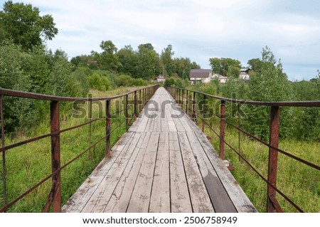 Similar – Image, Stock Photo Long wooden footbridge with an empty park bench at dusk