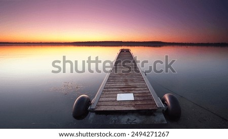 Similar – Image, Stock Photo Long wooden footbridge with an empty park bench at dusk