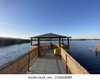 A Long Wooden Pier With A Beautiful Gazebo