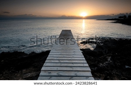 Long wooden pier in the sea at sunrice. Protaras Cyprus