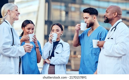 Long work hours require good cups of coffee. Shot of a group of doctors drinking coffee in the city. - Powered by Shutterstock