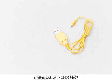 Long Yellow USB Cable On A Grey Background