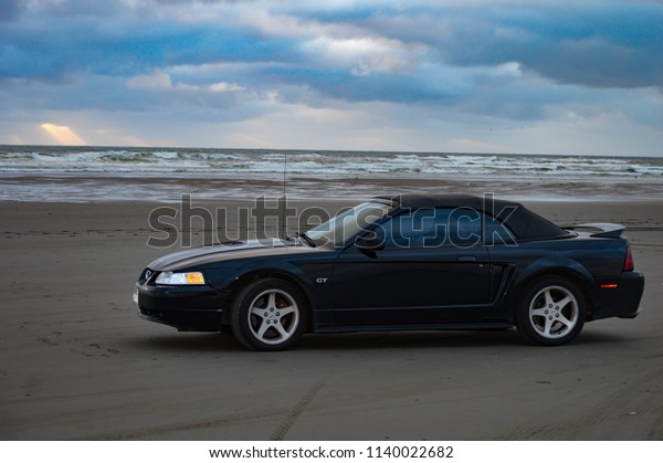 Longbeach, WA/USA\
6/15/2018 Garlic Festival staking out beach spot at sunset with a\
black Mustang\
Convertible\
