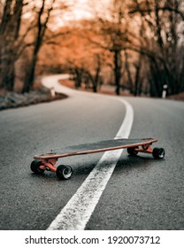 longboard on the forest road, orange longboard 
