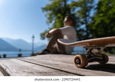 longboarder young man on a wooden ground outdoors, close-up skate wheel - Powered by Shutterstock