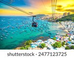 The longest cable car ride in the world, Phu Quoc island in South Vietnam, sunset sky. Below is traditional fishermen boats lined in the harbor of An Thoi town in the popular Hon Thom island.