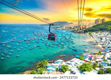 The longest cable car ride in the world, Phu Quoc island in South Vietnam, sunset sky. Below is traditional fishermen boats lined in the harbor of An Thoi town in the popular Hon Thom island. - Powered by Shutterstock