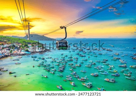 The longest cable car ride in the world, Phu Quoc island in South Vietnam, sunset sky. Below is traditional fishermen boats lined in the harbor of An Thoi town in the popular Hon Thom island.