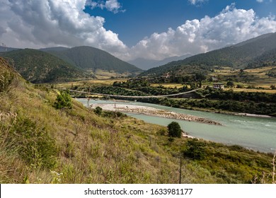 The longest suspension bridge in Himalaya near the town of Punakha in the Himalaya of Bhutan. Known for the Punakha Dzong, a 17th-century fortress at the juncture of the Pho and Mo Chhu rivers.  - Shutterstock ID 1633981177