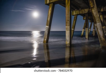 A long-exposure under a concrete fishing pier, at Wrightsville Beach, NC.
