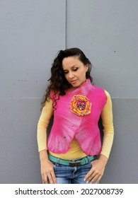 A Long-haired Brunette Poses In Front Of The Camera In A Vest. A Handmade Jacket And Brooch Made Of Merino Wool.