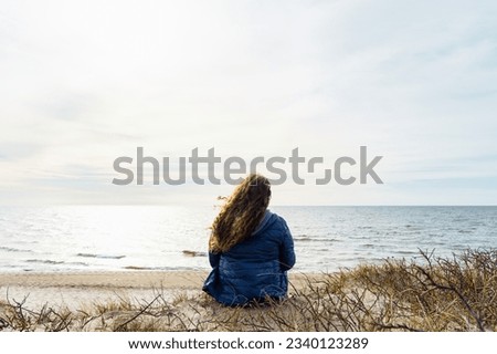 Similar – Image, Stock Photo Long-haired curly woman plus size in a wreath of red poppies stands among a field of meadow flowers and covers her face with a bouquet of poppies
