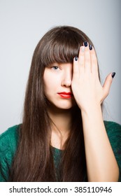 Long-haired Girl Close One Eye, An Ophthalmologist, A Student In Isolation On A Gray Background