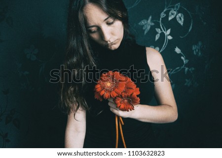 Similar – a girl with blue eyes and long hair covering herself with a gerbera flower