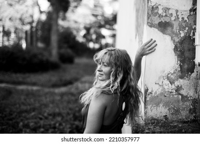 A Long-haired Slavic Woman In A Summer Village. Black And White Photo.