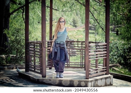 Similar – Beautiful young woman smiling and walking happy on the park outdoors