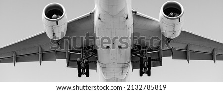 Long-haul airliner flying load over head during final approach with landing gear extended