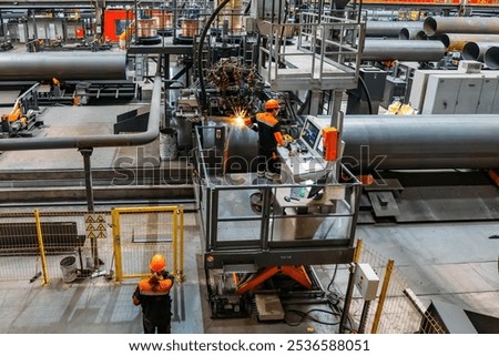 Longitudinal tack welding machine for welding of outer seam of steel pipe.