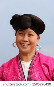 Longji, China - November 6, 2019: At Longji Rice Terrace Field, portrait of a woman of Miao minority people, with long hair