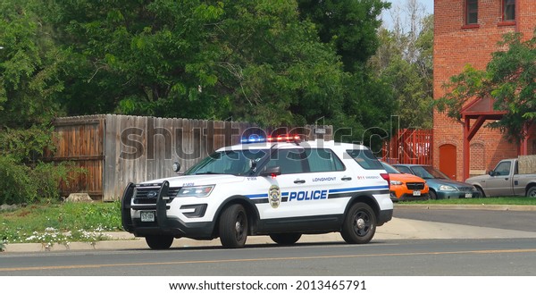 Longmont, CO USA - July 24, 2021: City of Longmont\
police cruiser with red and blue lights flashing                   \
           