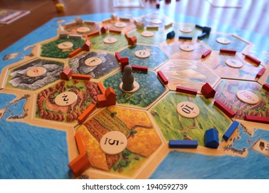 Longmont, CO USA - March 21, 2021: Settlers of Catan board game, set to play on a family table. Catan was introduced in 2002 and has sold over 32 million games.                               