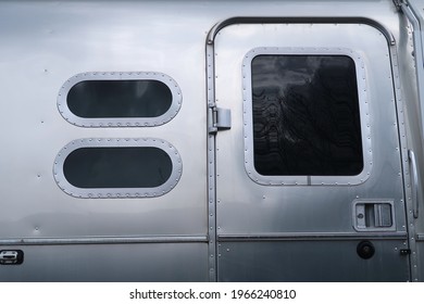 Longmont, CO USA - May 1, 2021: Airstream trailer windows and door with latch                             