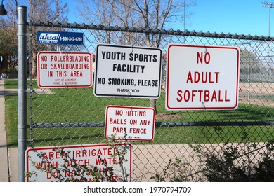 Longmont, CO USA - May 6, 2021: Signs Posted At A Sports Complex. No Adult Softball. Youth Sports Facility, No Smoking Please. No Hitting Balls On Any Park Fence.                               