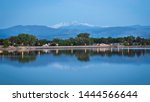 Longs Peak reflects in the waters of Lake Loveland during the blue hour of the morning