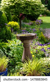 Longsdon, Staffordshire / England - 05 31 2019: English Country Garden With Stone Bird Bath