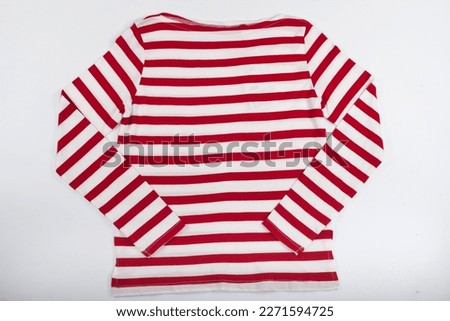 Long-sleeved red and white striped sweater isolated on a white background.