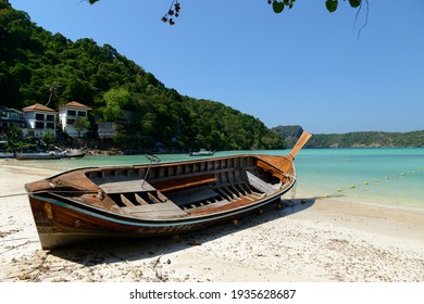 A long-tailed boat stranded on the beach for repairs at Loh Dalum Beach or Loh Dalum Bay, Koh Phi Phi Don, Krabi, Thailand.