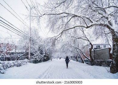 Longueuil, Qc, Canada - January 16th 2021: Woman Walking In The Empty Streets Of Longueuil Old Town On Snowfall Day In Quebec (Canada)