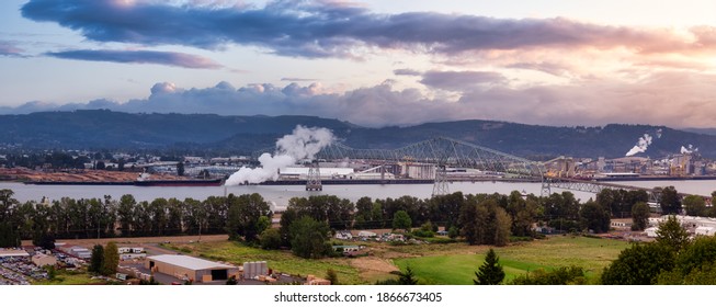 Longview, Washington, United States Of America. Aerial Panoramic View Of Port, Industrial Sites And Lewis And Clark Bridge Over Columbia River. Sunrise Sky