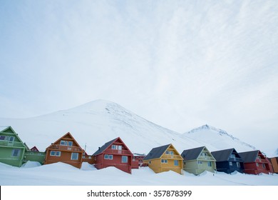 LONGYEARBYEN, SPITSBERGEN, NORWAY - APRIL 03, 2015: A small town in the far north of Europe among the snow-capped mountains. Stock Photo