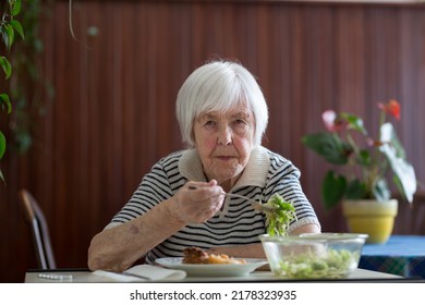 Lonley Solitary Elderly Woman Having Lunch Alone Sitting At The Table At Home. Lonely Late Life Period Of A Widow.